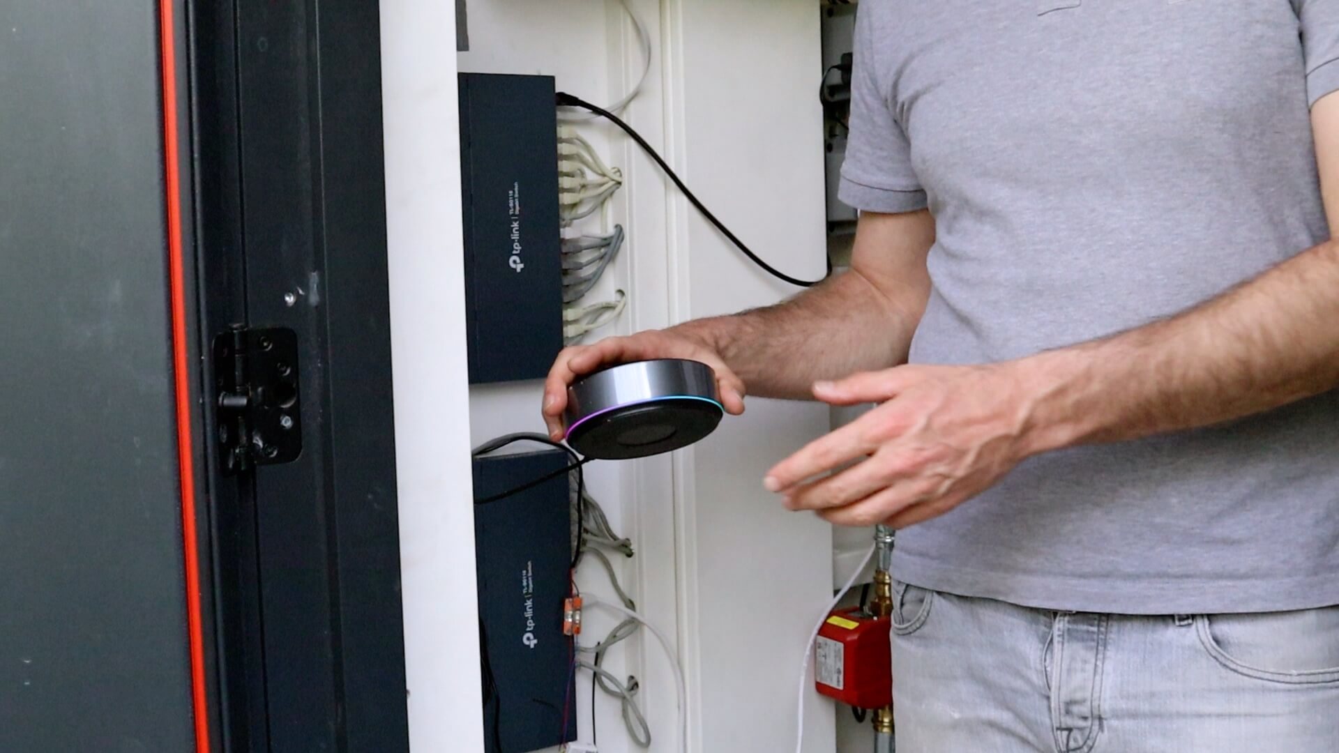 Jeroen holding a Homey Pro in his meter cupboard