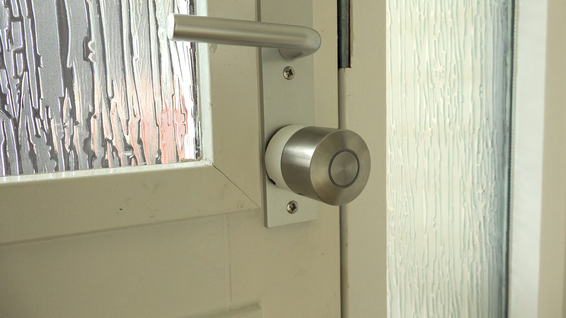 Close-up of a smart lock mounted on the inside of a front door