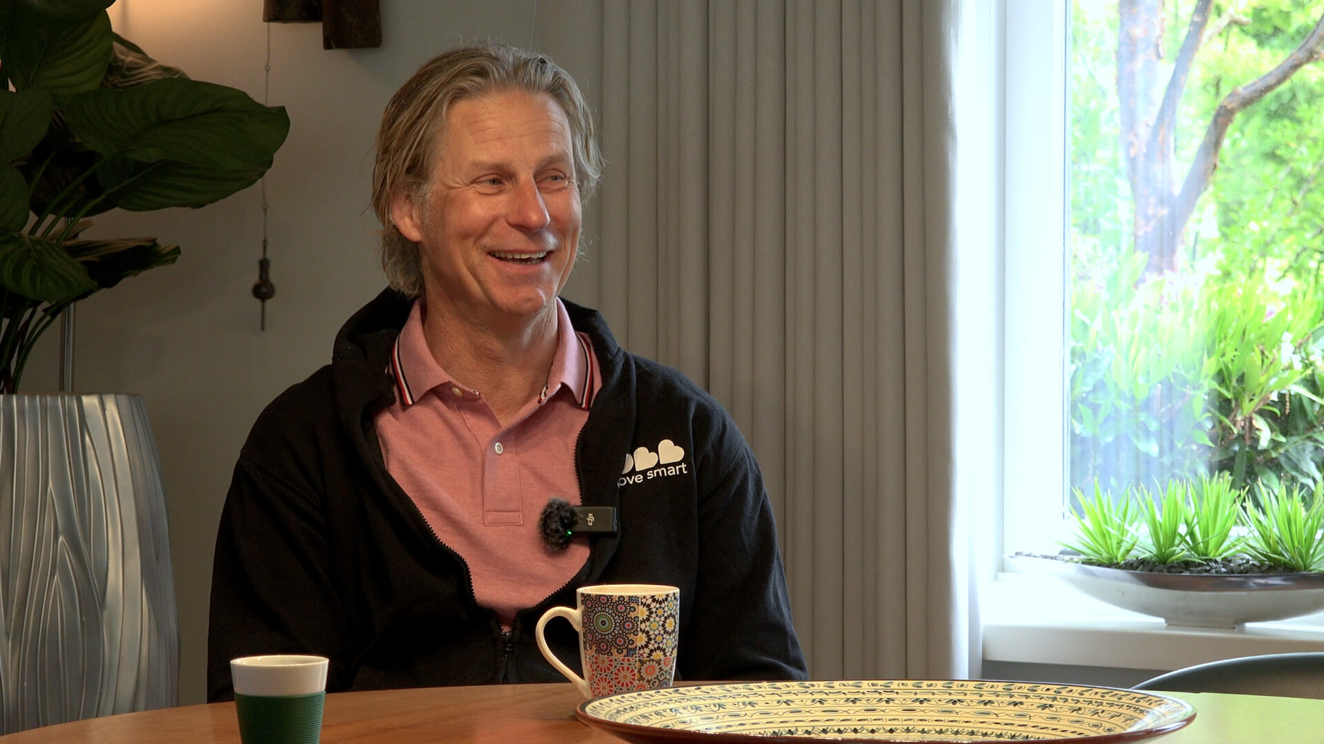 Rob from ROBBshop smiling during an interview at a table