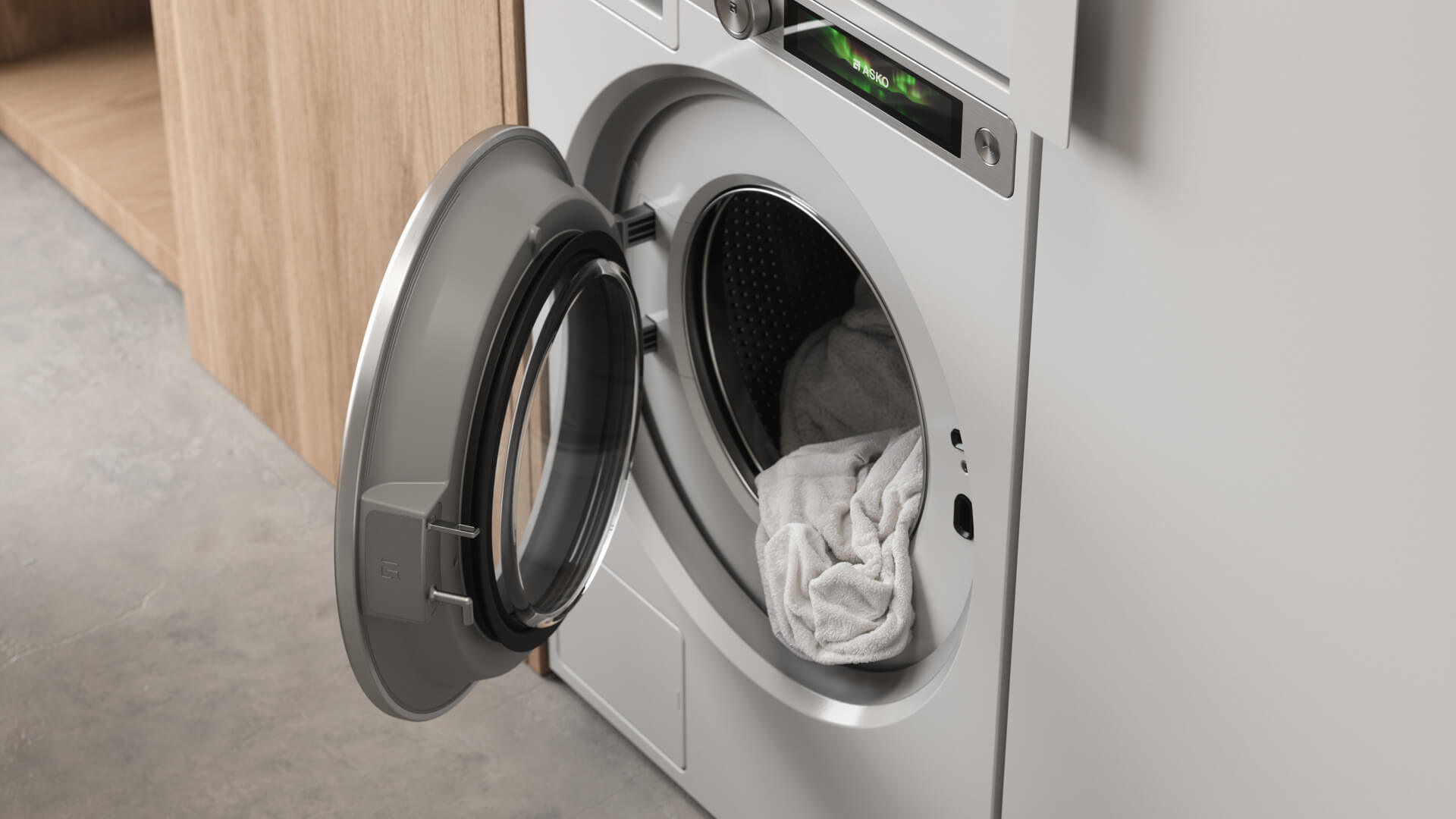Close-up of a white ASKO washing machine with its door open