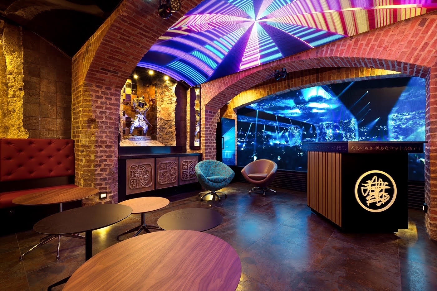 The VIP Room with brick arches, a large video wall, and an LED ceiling